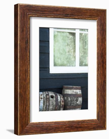 Rustic Barrels Lined Up Along an Old House Below a Window-Sheila Haddad-Framed Photographic Print