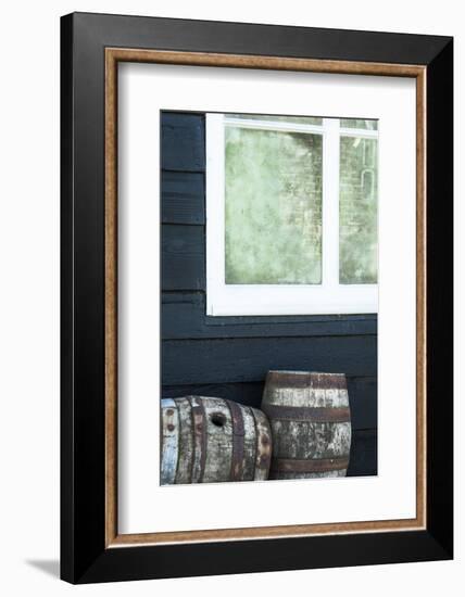 Rustic Barrels Lined Up Along an Old House Below a Window-Sheila Haddad-Framed Photographic Print