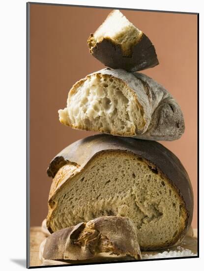 Rustic Bread, Two Loaves with Pieces Cut Off in a Pile-null-Mounted Photographic Print