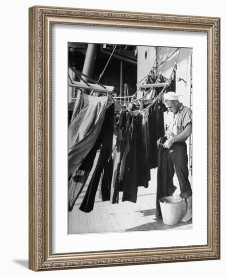 Sailor Aboard a Us Navy Cruiser at Sea Hanging Up Laundered Dungarees During WWII-Ralph Morse-Framed Photographic Print