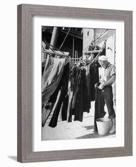 Sailor Aboard a Us Navy Cruiser at Sea Hanging Up Laundered Dungarees During WWII-Ralph Morse-Framed Photographic Print