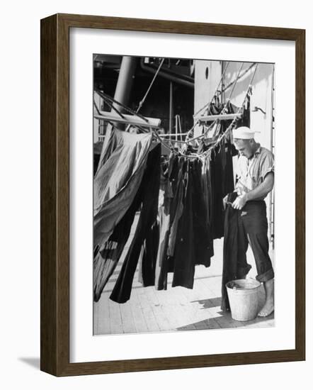 Sailor Aboard a Us Navy Cruiser at Sea Hanging Up Laundered Dungarees During WWII-Ralph Morse-Framed Photographic Print