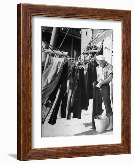 Sailor Aboard a Us Navy Cruiser at Sea Hanging Up Laundered Dungarees During WWII-Ralph Morse-Framed Photographic Print