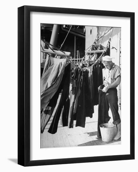 Sailor Aboard a Us Navy Cruiser at Sea Hanging Up Laundered Dungarees During WWII-Ralph Morse-Framed Photographic Print