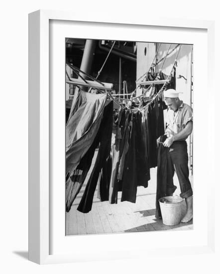 Sailor Aboard a Us Navy Cruiser at Sea Hanging Up Laundered Dungarees During WWII-Ralph Morse-Framed Photographic Print