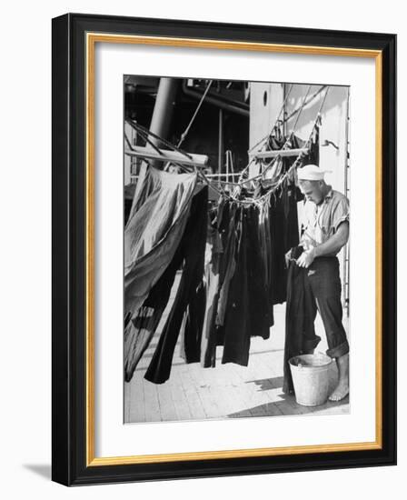 Sailor Aboard a Us Navy Cruiser at Sea Hanging Up Laundered Dungarees During WWII-Ralph Morse-Framed Photographic Print