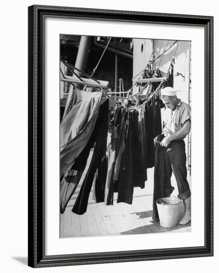 Sailor Aboard a Us Navy Cruiser at Sea Hanging Up Laundered Dungarees During WWII-Ralph Morse-Framed Photographic Print