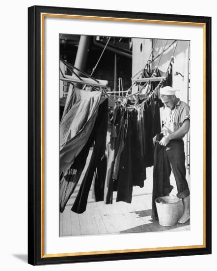 Sailor Aboard a Us Navy Cruiser at Sea Hanging Up Laundered Dungarees During WWII-Ralph Morse-Framed Photographic Print