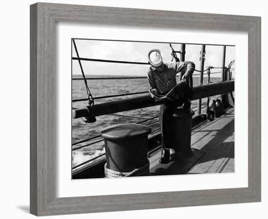 Sailor Relaxing Aboard a Us Navy Cruiser at Sea While Reading a Copy of Life Magazine During WWII-Ralph Morse-Framed Photographic Print