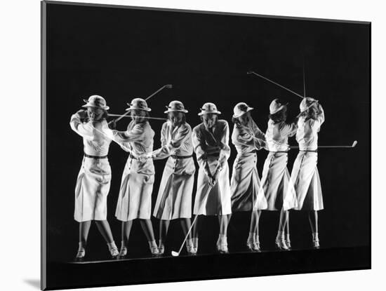 Saks Fifth Avenue Fashion Shot of Model Swinging Golf Club-Gjon Mili-Mounted Photographic Print