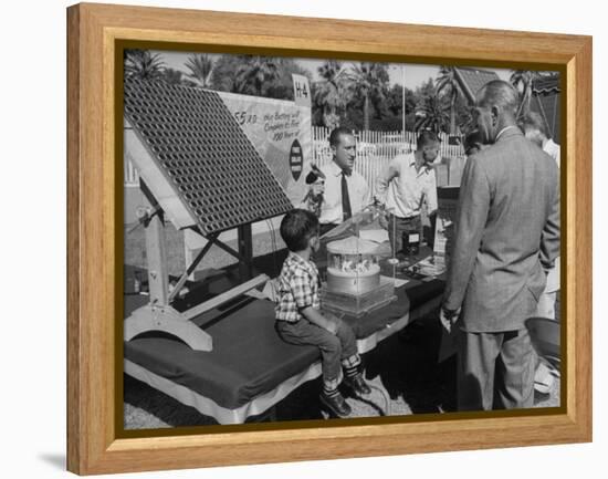 Salesman Demonstrating Solar Battery at the International Conference on Solar Energy-J^ R^ Eyerman-Framed Premier Image Canvas