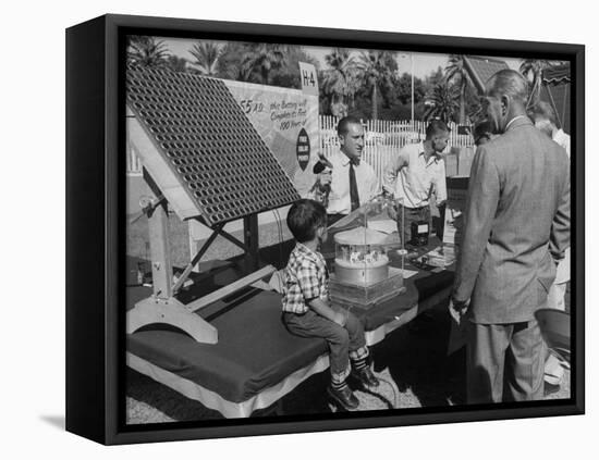 Salesman Demonstrating Solar Battery at the International Conference on Solar Energy-J^ R^ Eyerman-Framed Premier Image Canvas