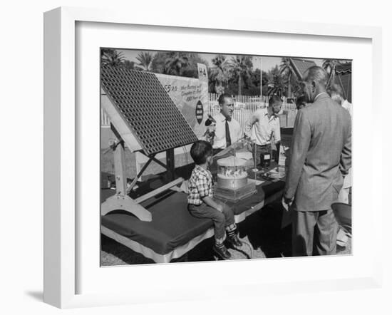 Salesman Demonstrating Solar Battery at the International Conference on Solar Energy-J^ R^ Eyerman-Framed Photographic Print