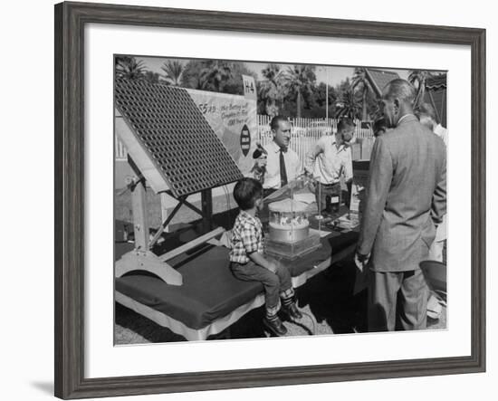 Salesman Demonstrating Solar Battery at the International Conference on Solar Energy-J^ R^ Eyerman-Framed Photographic Print