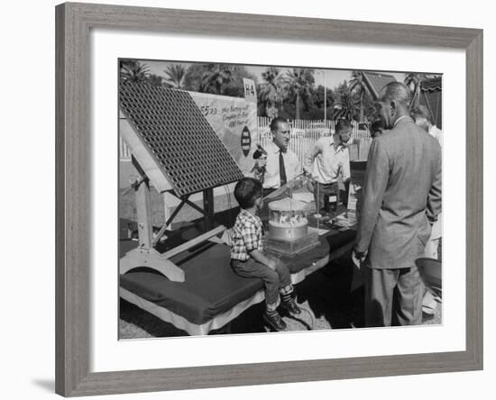 Salesman Demonstrating Solar Battery at the International Conference on Solar Energy-J^ R^ Eyerman-Framed Photographic Print