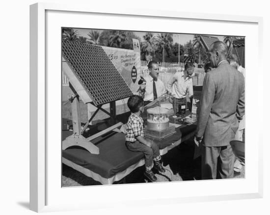 Salesman Demonstrating Solar Battery at the International Conference on Solar Energy-J^ R^ Eyerman-Framed Photographic Print