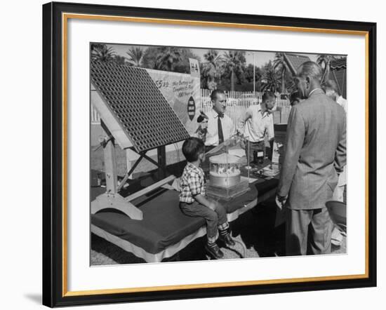 Salesman Demonstrating Solar Battery at the International Conference on Solar Energy-J^ R^ Eyerman-Framed Photographic Print