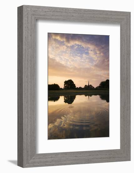 Salisbury Cathedral Spire and a beautiful dawn sky reflected in a rippled pond, Salisbury, Wiltshir-Adam Burton-Framed Photographic Print