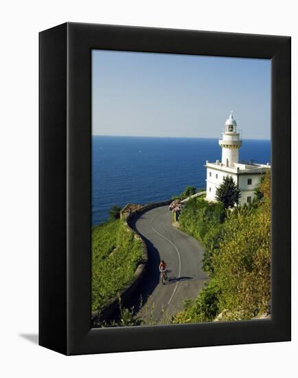 San Sebastian Bay Clifftop Lighthouse with Cyclist Riding Uphill-Christian Kober-Framed Premier Image Canvas