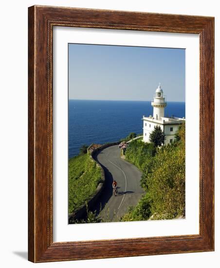 San Sebastian Bay Clifftop Lighthouse with Cyclist Riding Uphill-Christian Kober-Framed Photographic Print