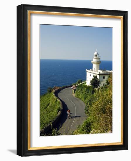 San Sebastian Bay Clifftop Lighthouse with Cyclist Riding Uphill-Christian Kober-Framed Photographic Print