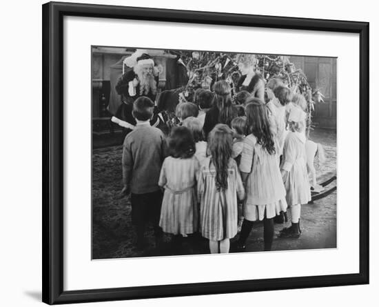 Santa Claus Visiting with Large Group of Children-null-Framed Photo