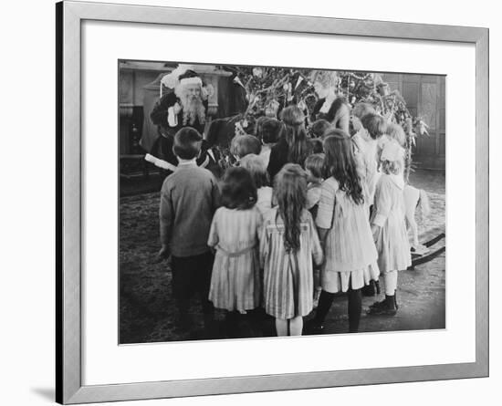 Santa Claus Visiting with Large Group of Children-null-Framed Photo