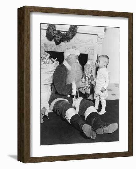 Santa Claus with a Little Boy and a Teddy Bear in Front of a Fire Place-null-Framed Photo