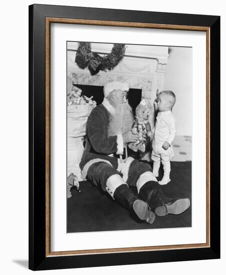 Santa Claus with a Little Boy and a Teddy Bear in Front of a Fire Place-null-Framed Photo