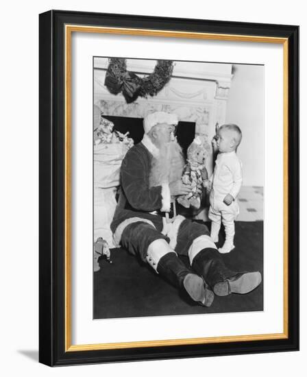 Santa Claus with a Little Boy and a Teddy Bear in Front of a Fire Place-null-Framed Photo