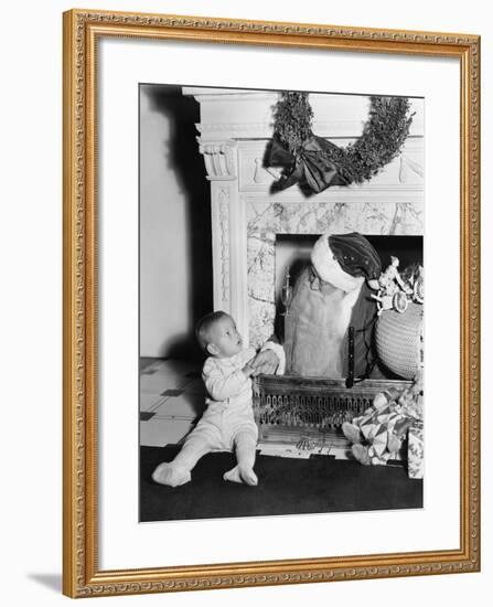 Santa Claus with a Little Boy in Front of a Fireplace-null-Framed Photo