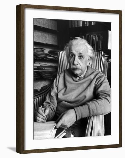 Scientist Albert Einstein Wearing Old Sweat Shirt, Sitting with Page of Equations in Home Library-Alfred Eisenstaedt-Framed Premium Photographic Print