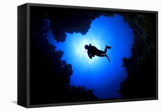 Scuba Diver Swims over Underwater Cave, Silhouette against Sun-Rich Carey-Framed Premier Image Canvas