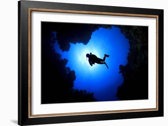 Scuba Diver Swims over Underwater Cave, Silhouette against Sun-Rich Carey-Framed Photographic Print