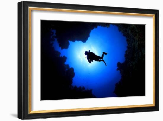 Scuba Diver Swims over Underwater Cave, Silhouette against Sun-Rich Carey-Framed Photographic Print
