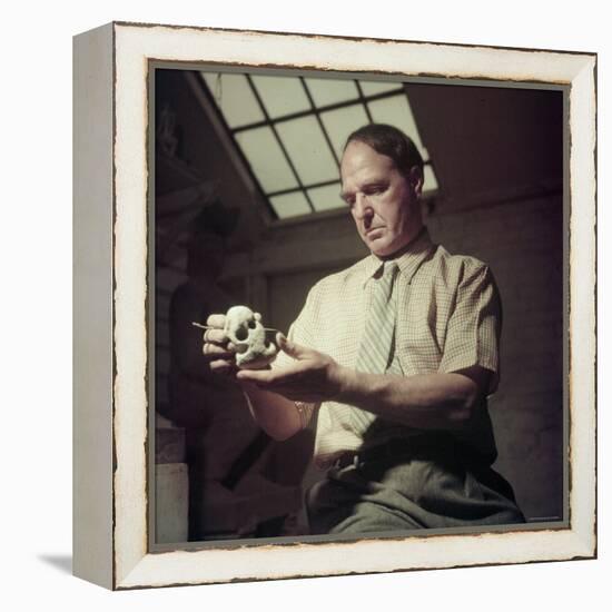 Sculptor Henry Moore Holding a Small Sculpture in His Studio in Much Hadham, England-Gjon Mili-Framed Premier Image Canvas