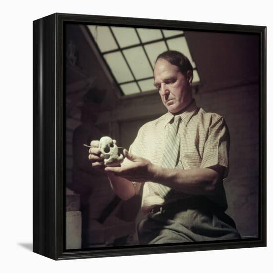 Sculptor Henry Moore Holding a Small Sculpture in His Studio in Much Hadham, England-Gjon Mili-Framed Premier Image Canvas