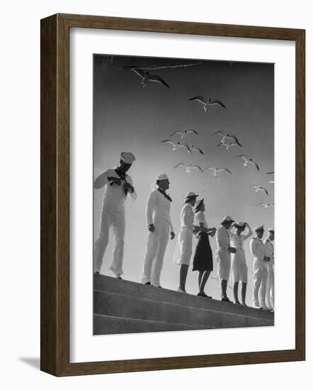 Seagulls Flying Above Group of Sailors and Waves-Alfred Eisenstaedt-Framed Photographic Print