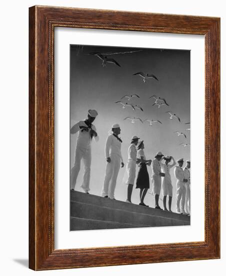 Seagulls Flying Above Group of Sailors and Waves-Alfred Eisenstaedt-Framed Photographic Print