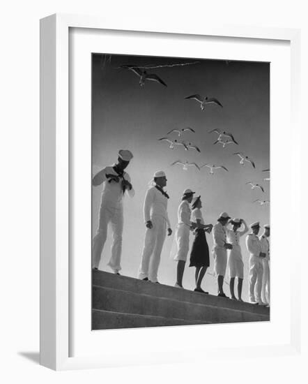 Seagulls Flying Above Group of Sailors and Waves-Alfred Eisenstaedt-Framed Photographic Print