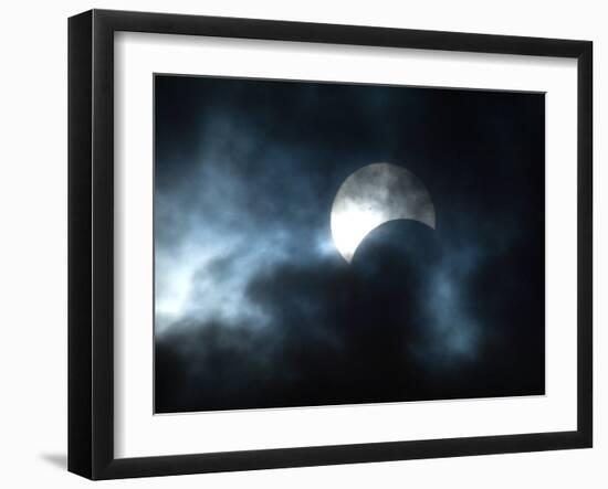 Seen Through Clouds the Sun is Partially Obscured by the Moon During an Eclipse-null-Framed Photographic Print