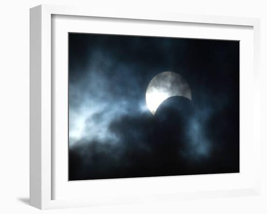 Seen Through Clouds the Sun is Partially Obscured by the Moon During an Eclipse-null-Framed Photographic Print