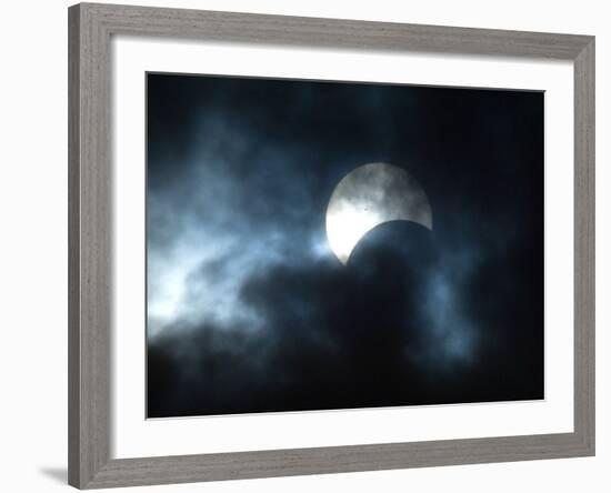 Seen Through Clouds the Sun is Partially Obscured by the Moon During an Eclipse-null-Framed Photographic Print