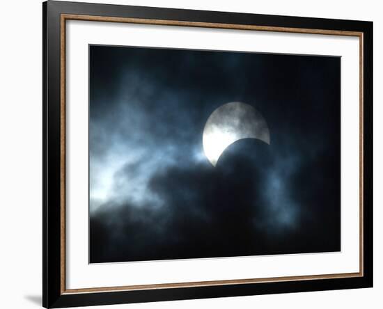 Seen Through Clouds the Sun is Partially Obscured by the Moon During an Eclipse-null-Framed Photographic Print