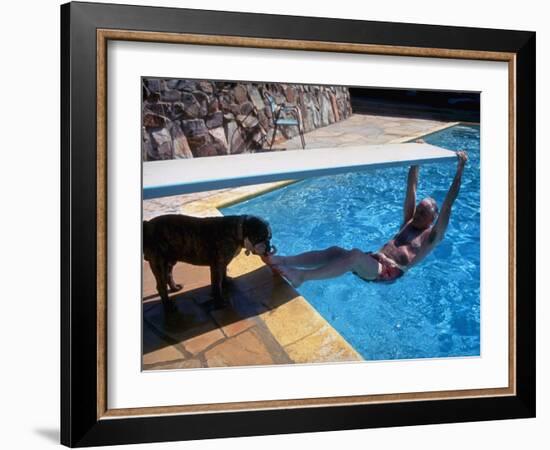 Sen. Barry Goldwater Hanging Underneath Diving Board in Swimming Pool as Dog Licks His Toes-Bill Ray-Framed Photographic Print