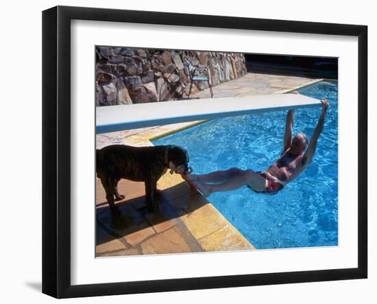 Sen. Barry Goldwater Hanging Underneath Diving Board in Swimming Pool as Dog Licks His Toes-Bill Ray-Framed Photographic Print