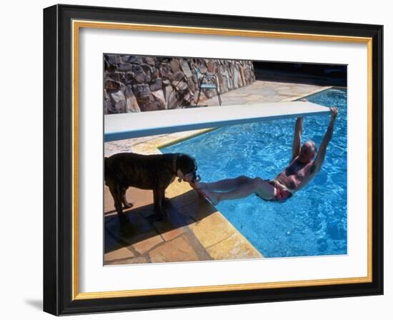 Sen. Barry Goldwater Hanging Underneath Diving Board in Swimming Pool as Dog Licks His Toes-Bill Ray-Framed Photographic Print