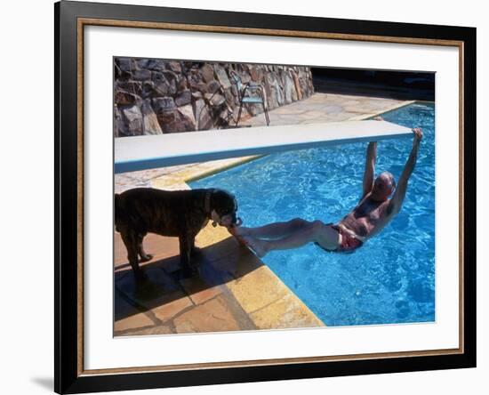 Sen. Barry Goldwater Hanging Underneath Diving Board in Swimming Pool as Dog Licks His Toes-Bill Ray-Framed Photographic Print