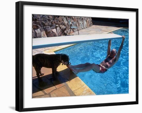 Sen. Barry Goldwater Hanging Underneath Diving Board in Swimming Pool as Dog Licks His Toes-Bill Ray-Framed Photographic Print