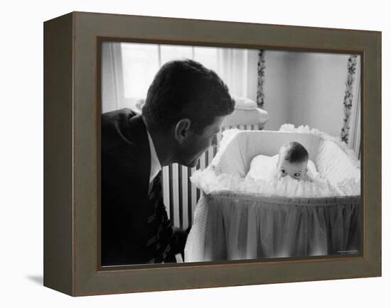 Sen. Jack Kennedy Admiring Baby Caroline as She Lies in Her Crib in Nursery at Georgetown Home-Ed Clark-Framed Premier Image Canvas
